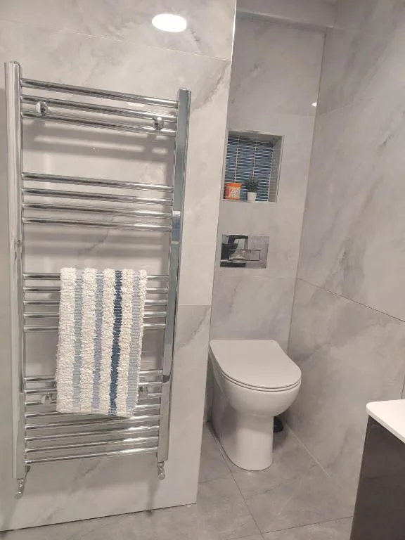 Bathroom with heated towel rail and WC
