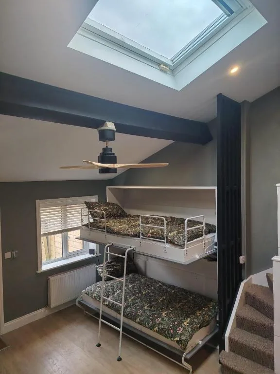 Bunk beds beneath a large skylight