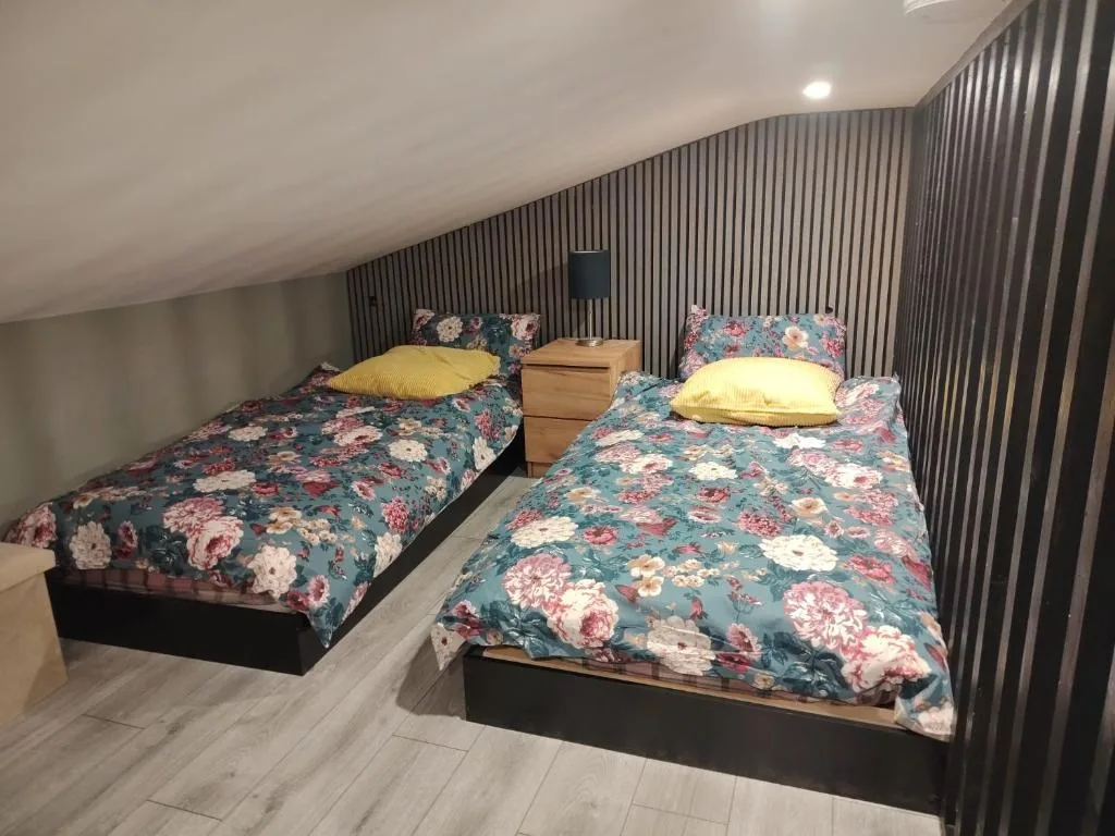Twin bedroom in the loft with floral bedding